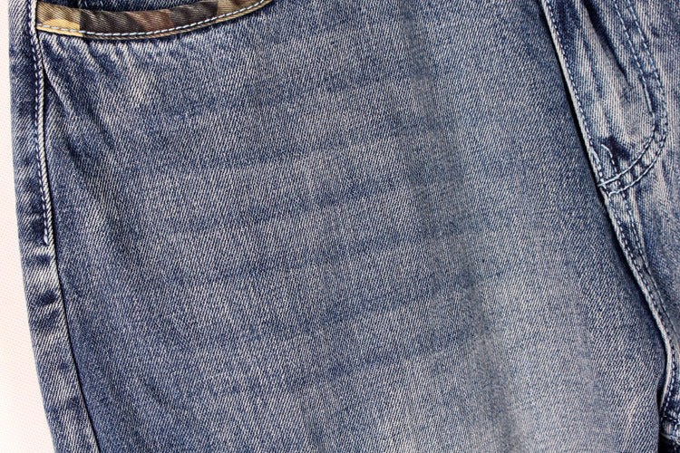 Close-up of men's baggy denim shorts showcasing the lightweight fabric and pocket detail for streetwear style.