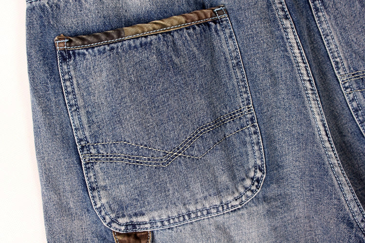 Close-up of a pocket on men's denim cargo shorts featuring blue fabric and stylish stitching.
