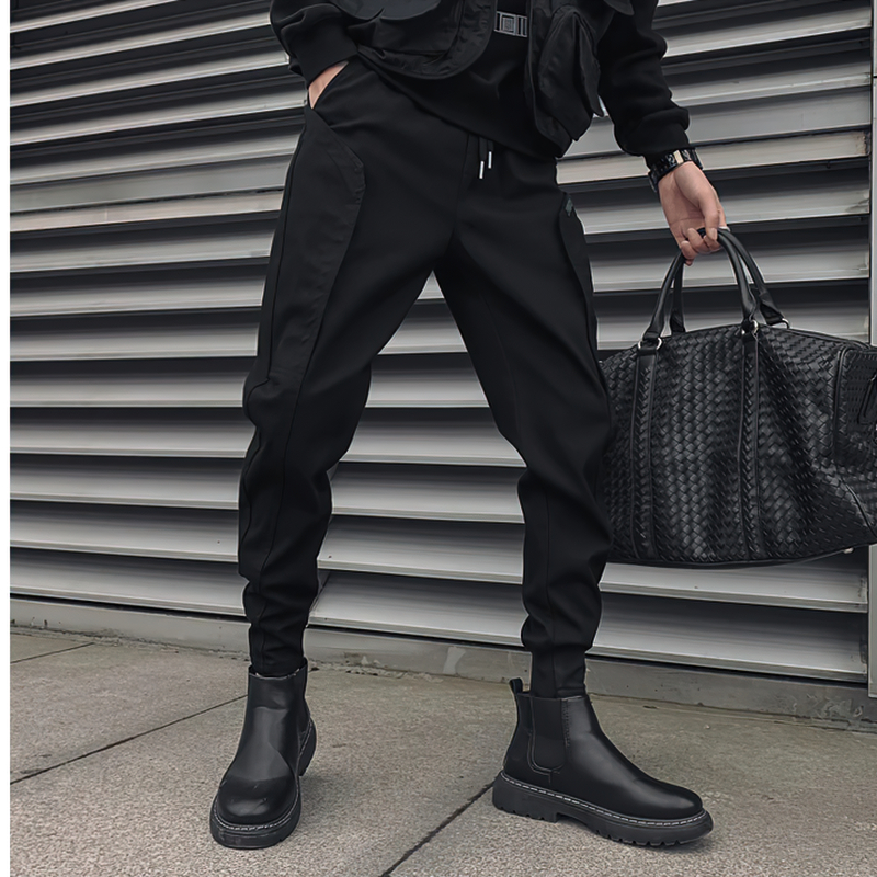 Stylish men's black drawstring pants paired with trendy black boots, showcasing a modern casual look.