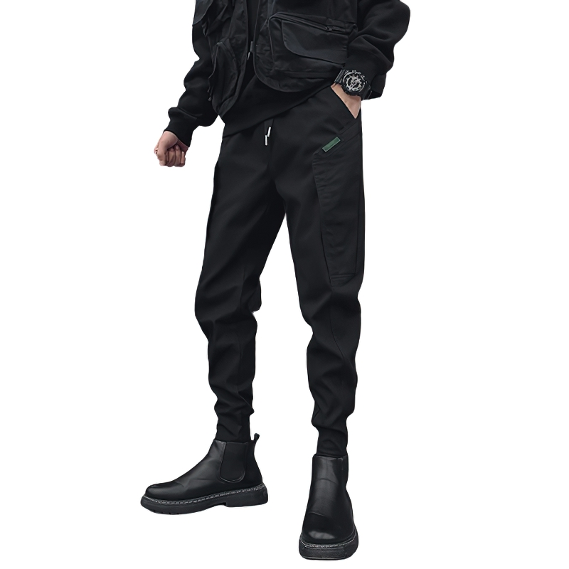 Stylish man's drawstring black cotton pants with modern tapered cut, perfect for casual wear.