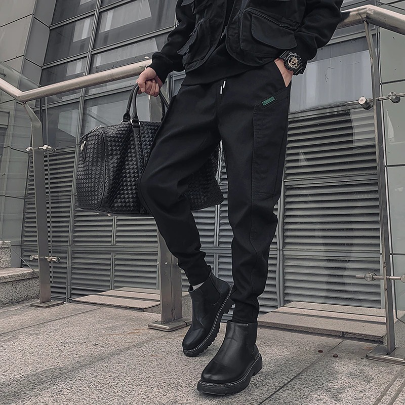 Stylish men's drawstring black cotton pants paired with sleek boots, showcasing modern casual fashion.