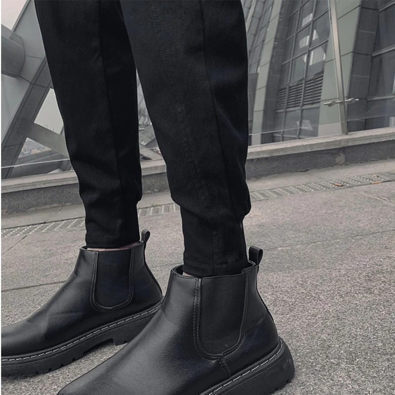 Stylish men's drawstring black cotton pants paired with sleek black ankle boots, showcasing modern fashion.