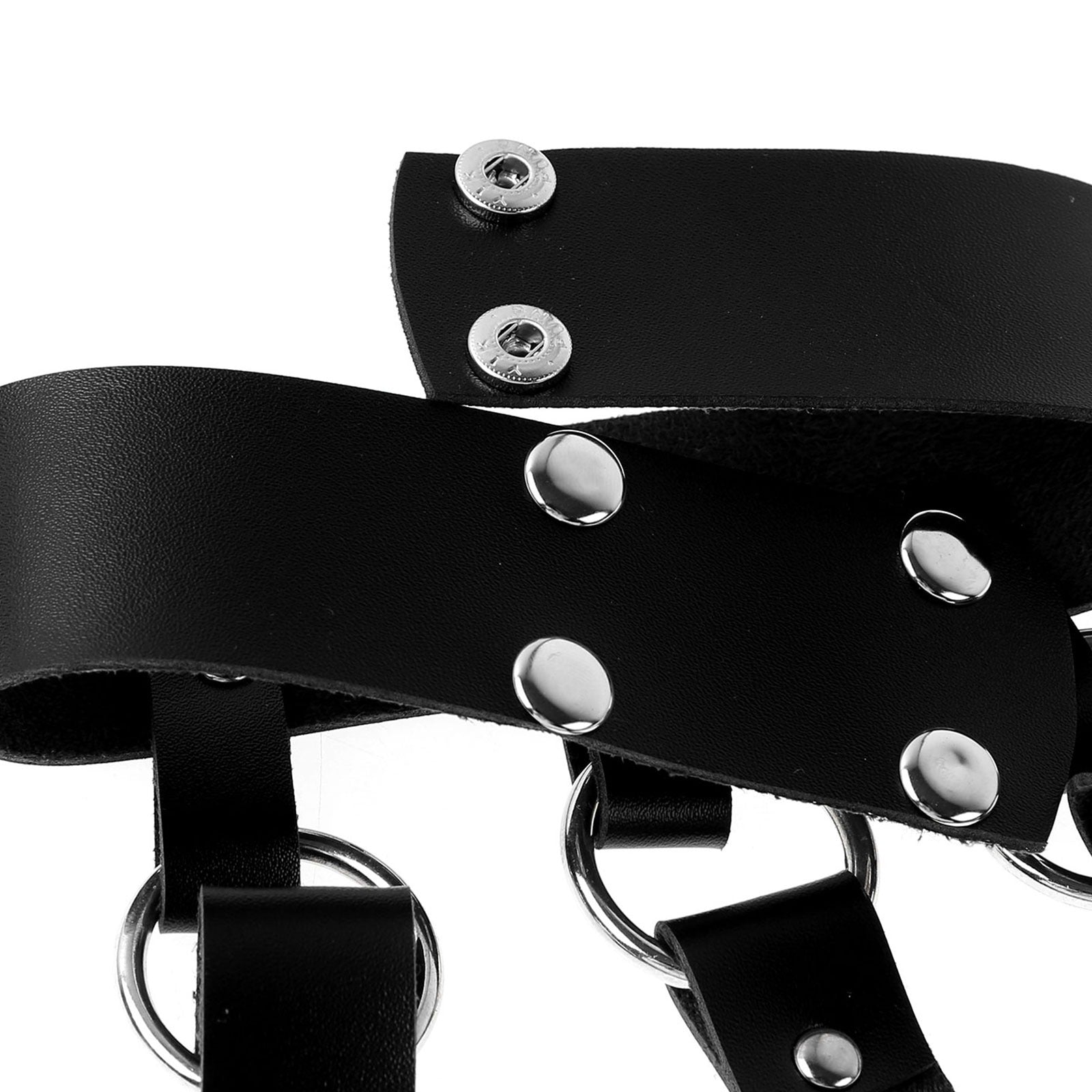 Close-up of black PU leather harness with silver studs and rings for a gothic fashion statement.