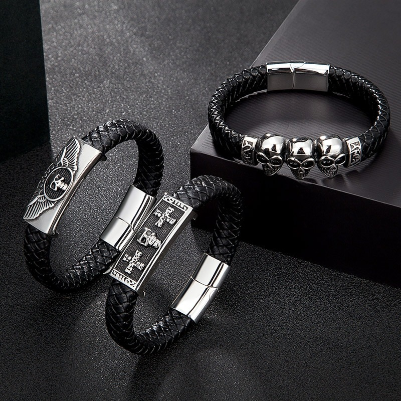 Men's gothic leather bracelets featuring skull designs and stainless steel buckles on a dark background.