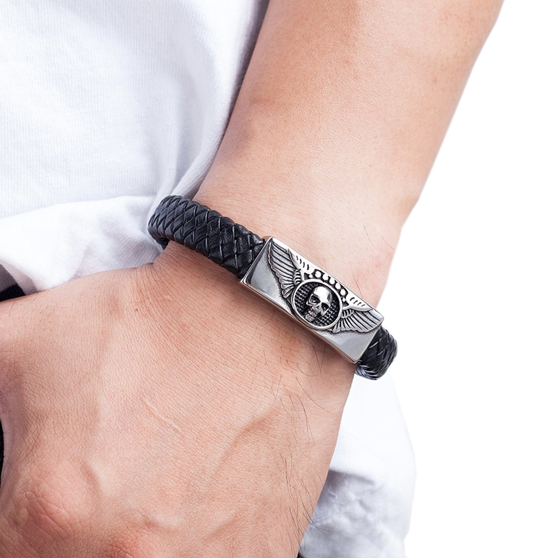 Men's black leather bracelet with skull and winged magnetic buckle, showcasing a stylish gothic punk design.