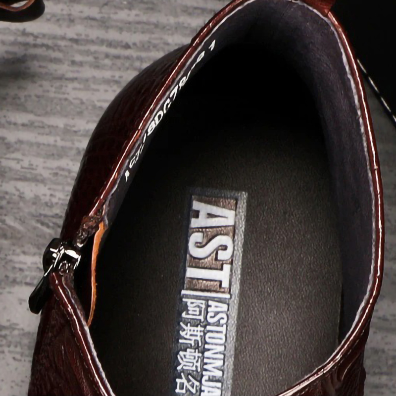 Interior view of a brown men's leather boot showing the zip and brand label, perfect for casual style.
