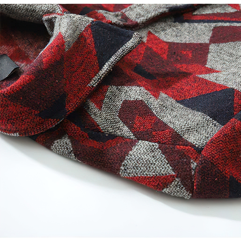 Close-up of men's shirt featuring a geometric pattern in red, black, and gray hues, showcasing casual style and big pockets.