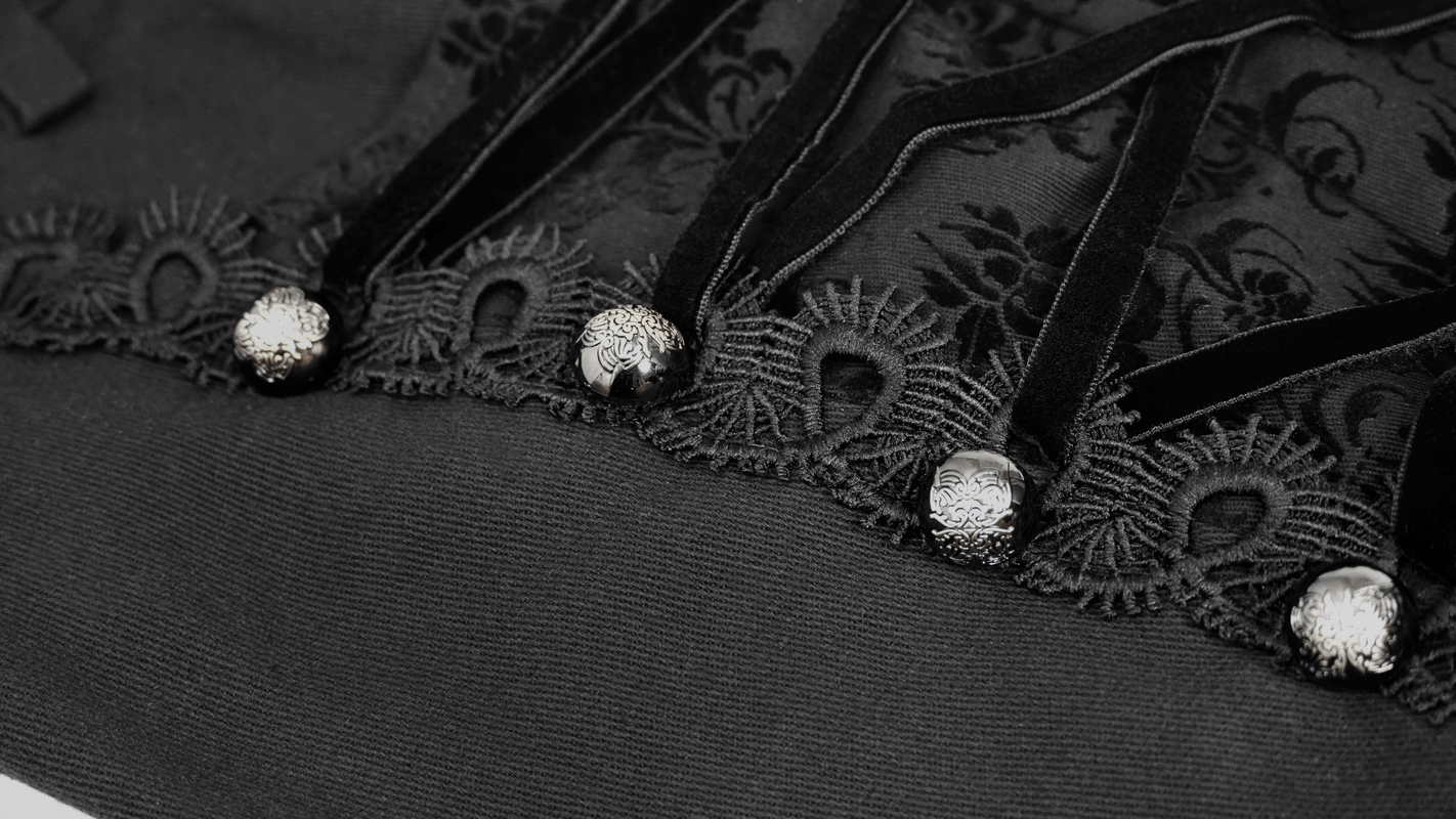 Close-up of gothic black jacquard fabric with intricate silver rivets and lace trim, highlighting men's stylish pocket pants design.