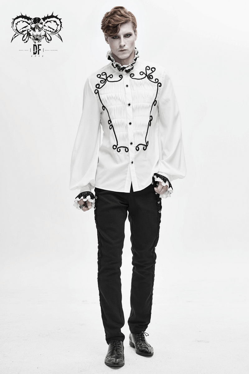 Men's gothic fashion model wearing black pants with silver rivets and a white embroidered shirt, showcasing stylish gothic clothing.