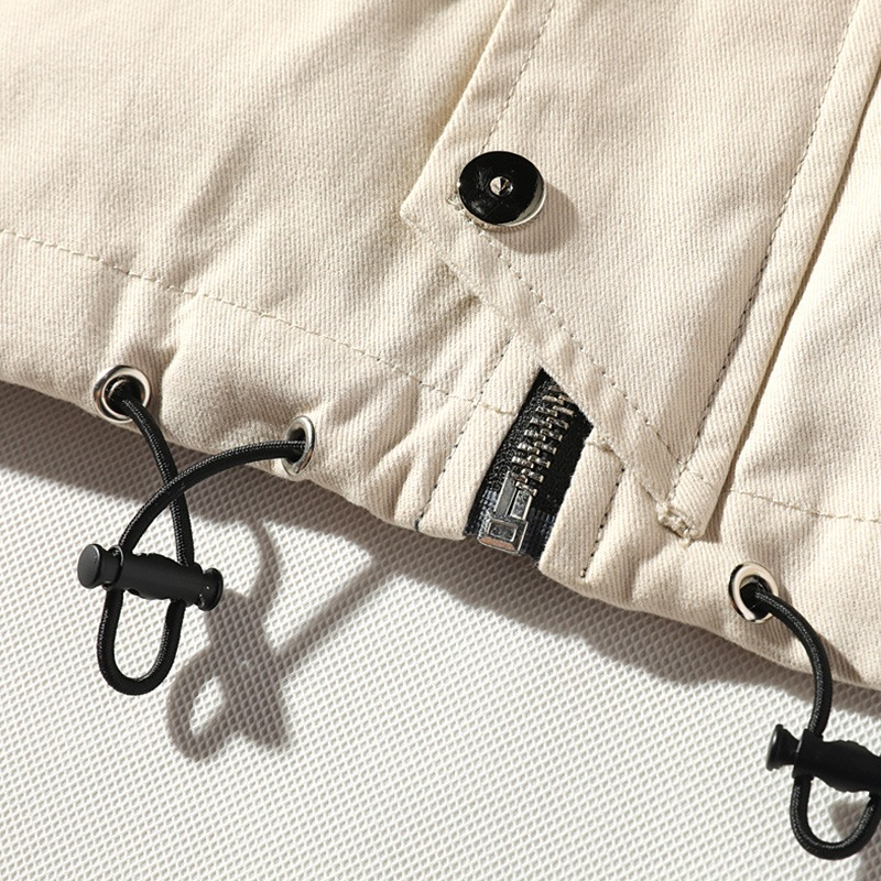 Close-up of men's casual cotton jacket showing multi-pocket design and adjustable drawstrings for a stylish look.