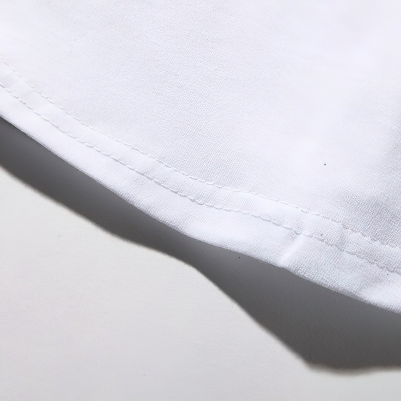 Close-up of the hem of a white men's patchwork leather t-shirt showcasing a casual summer style.