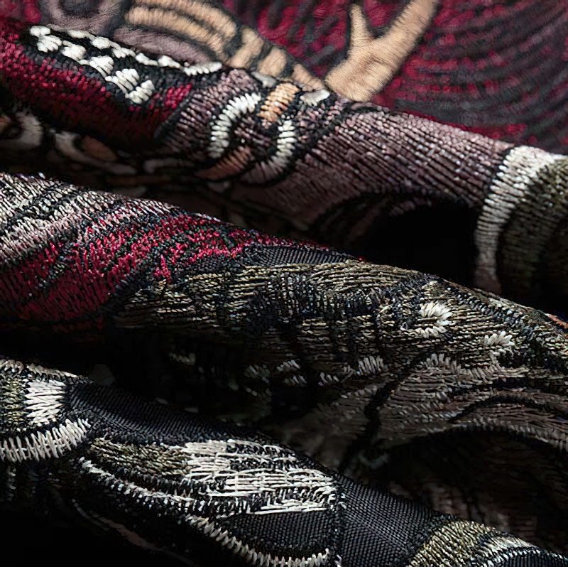 Close-up of intricate embroidery patterns in rich colors for men's oversized black jacket, enhancing casual streetwear style.