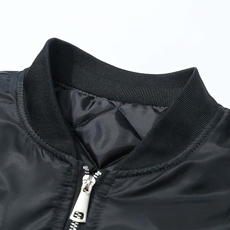 Close-up of the collar and zipper of a stylish black oversized men's jacket.