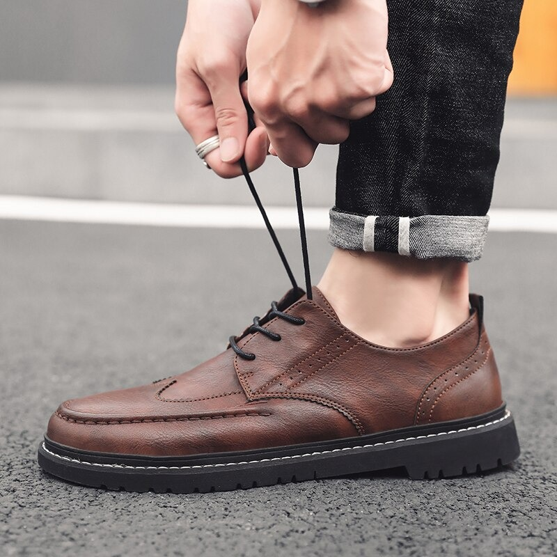 Men's brown leather lace-up dress shoes with flat sole, perfect for casual elegance in British style.