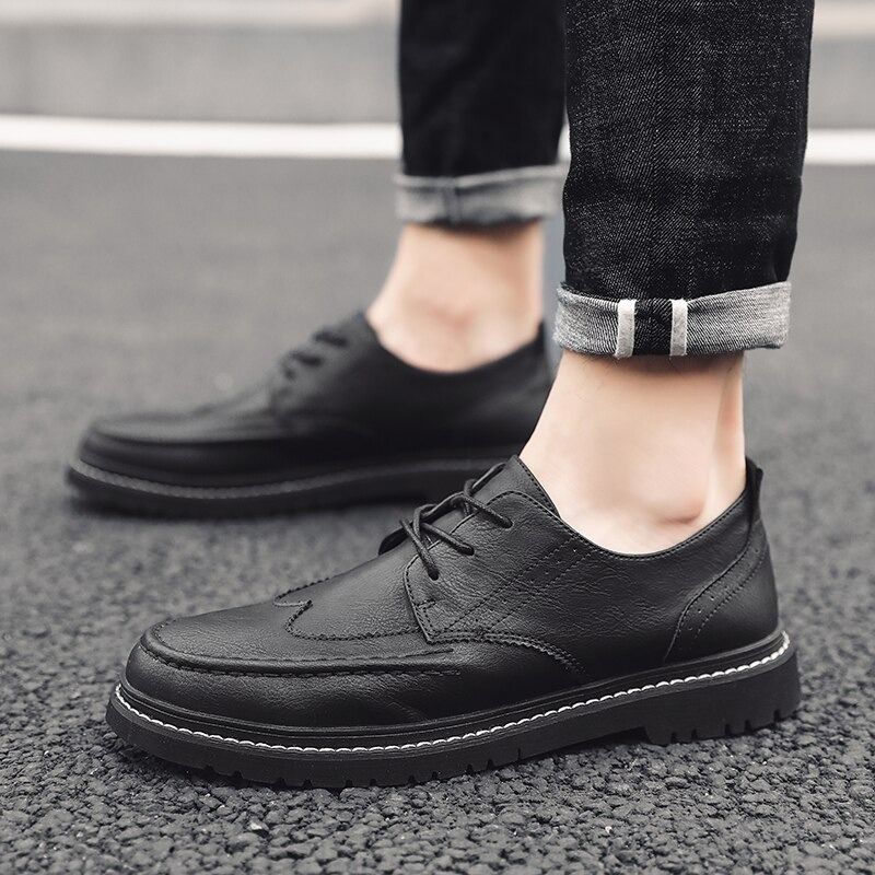 Men's black leather dress shoes, lace-up, flat sole, perfect for casual and stylish wear.