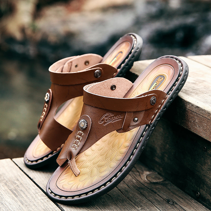 Men's brown leather sandals on wooden surface, perfect for summer outings and casual wear.