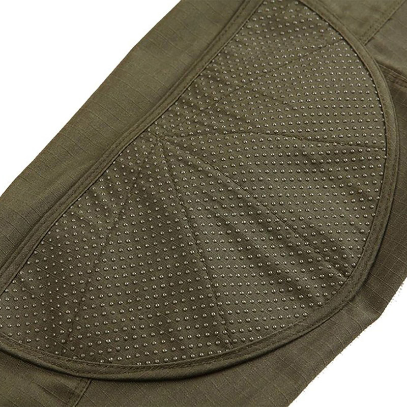 Close-up of durable olive green material with breathable fabric and textured detailing for military-style clothing.