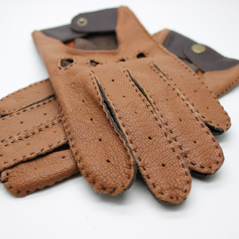 Close-up of brown leather men's motorcycle riding gloves with full fingers and classic biker style accents.