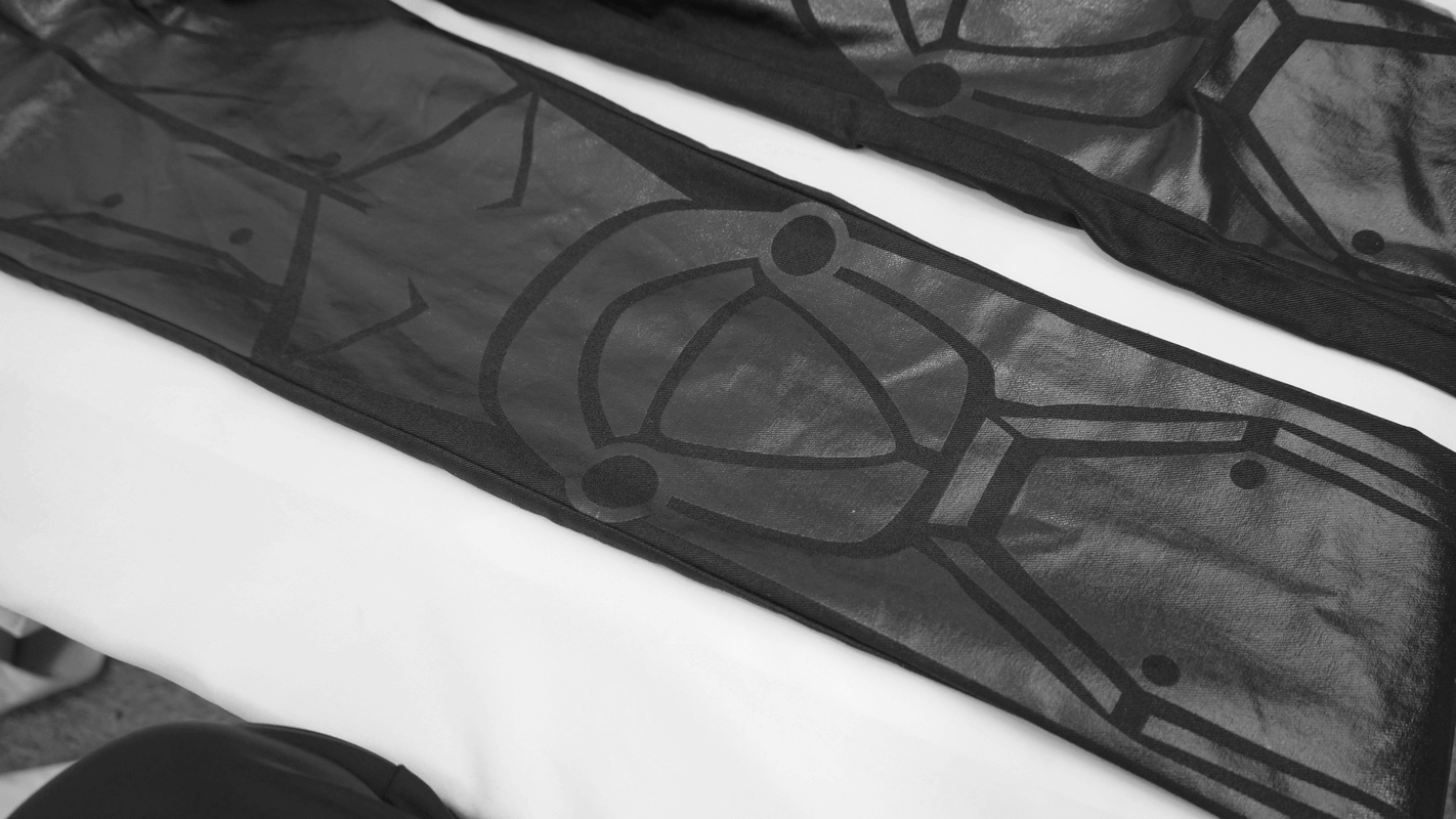 Men's cyberpunk skinny trousers featuring unique spliced stripe designs and a sleek black fabric.