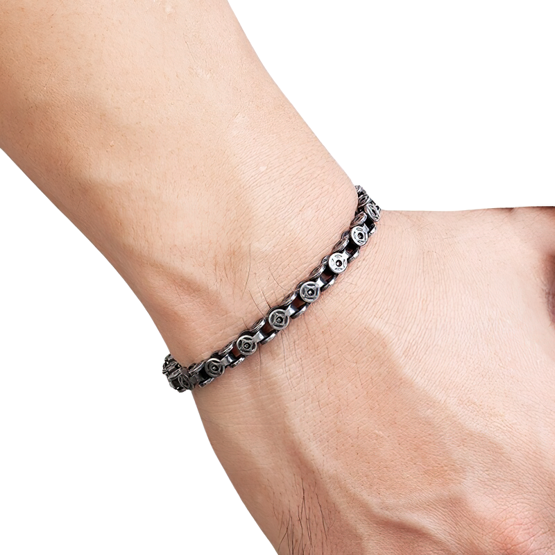 Men's punk style dark gray stainless steel bracelet on wrist, featuring stylish cross design for a trendy look.