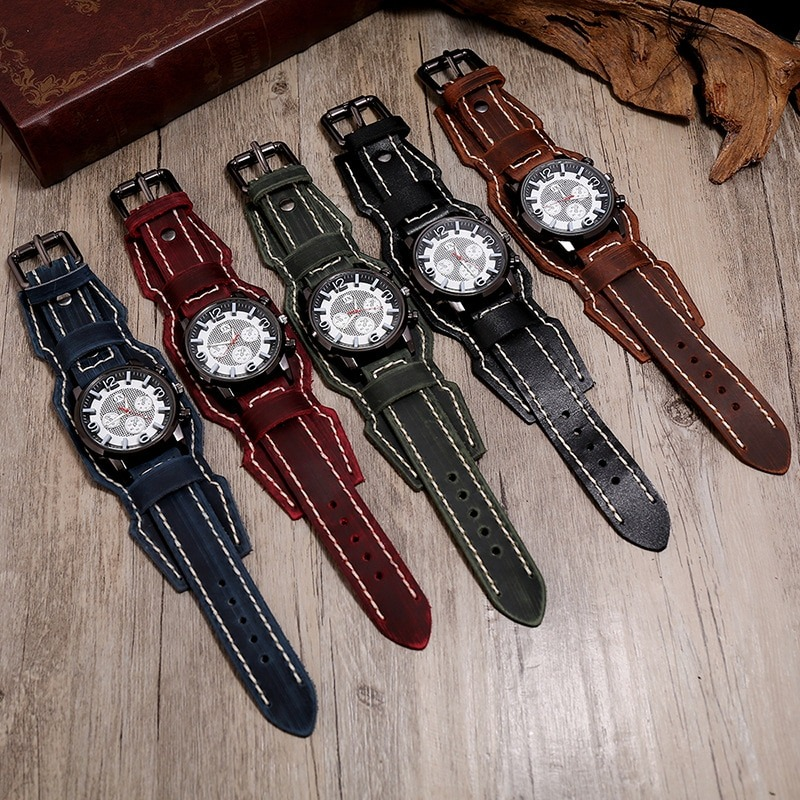 Men's retro rock style quartz watches with vintage leather bands in five colors displayed on a wooden surface.