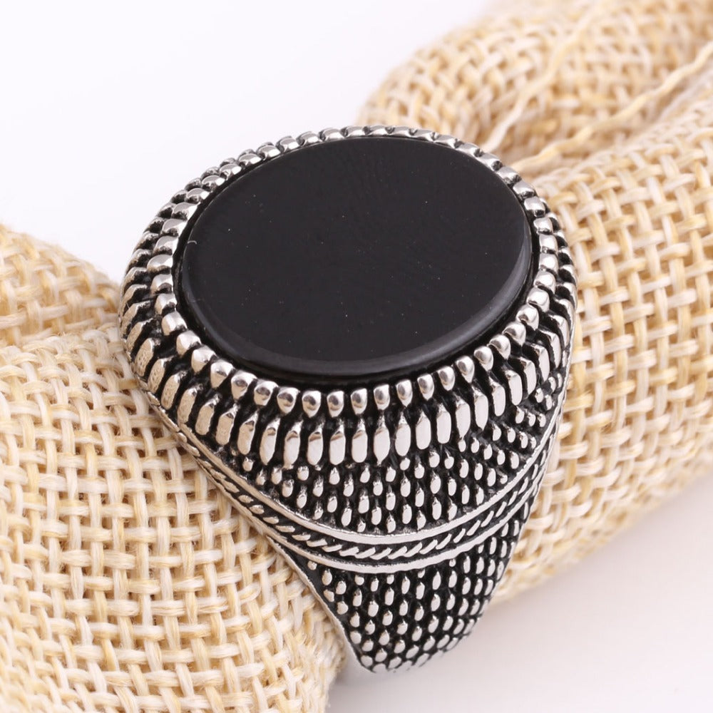 Men's vintage stainless steel ring with black stone, hypoallergenic, stylish design, perfect as a wedding ring.