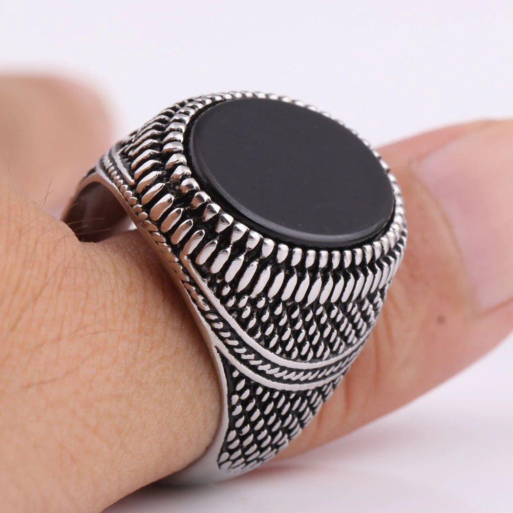 Vintage silver-plated men's ring with black stone set on a finger, crafted from 316L stainless steel, stylish and hypoallergenic.