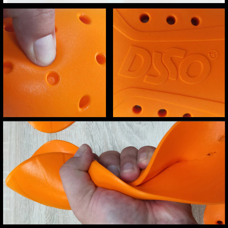 Close-up of flexible orange material with raised dots and logo, ideal for sports or ergonomic use.