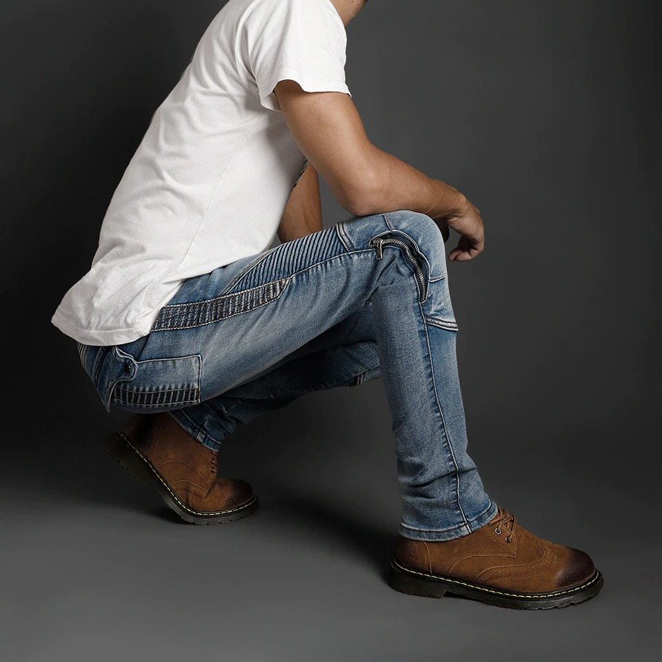 Men's biker style slim jeans in blue, paired with a white shirt and brown shoes, showcasing a stylish casual look.