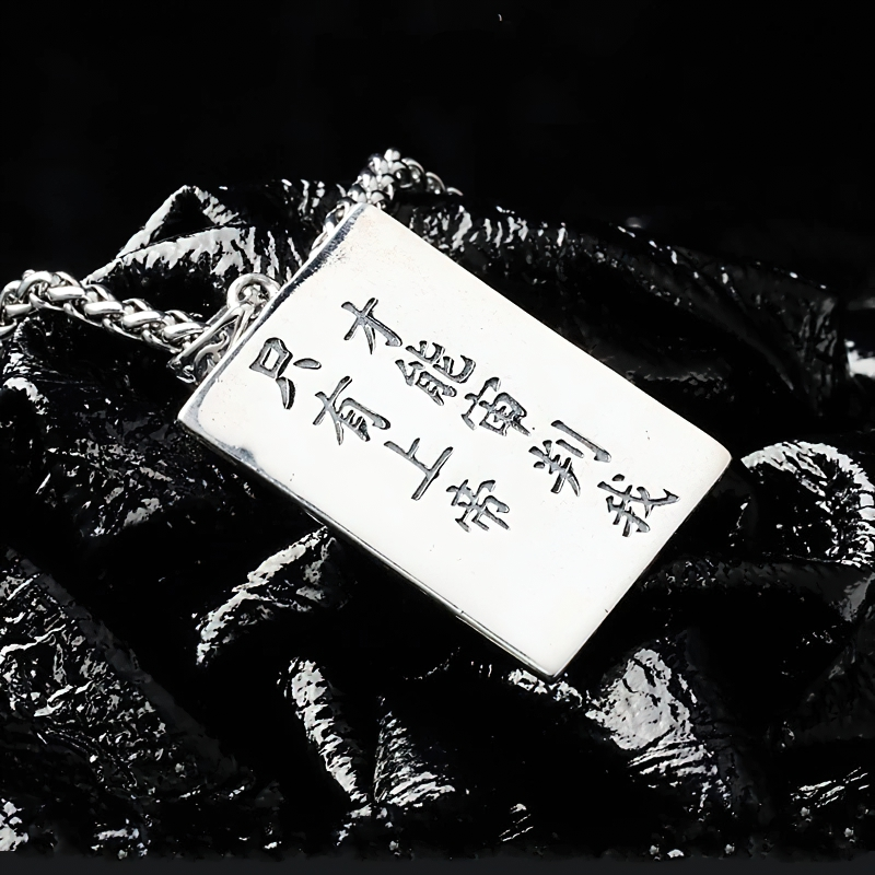 Men's sterling silver pendant with skull design on a black background, perfect for alternative rock fashion.