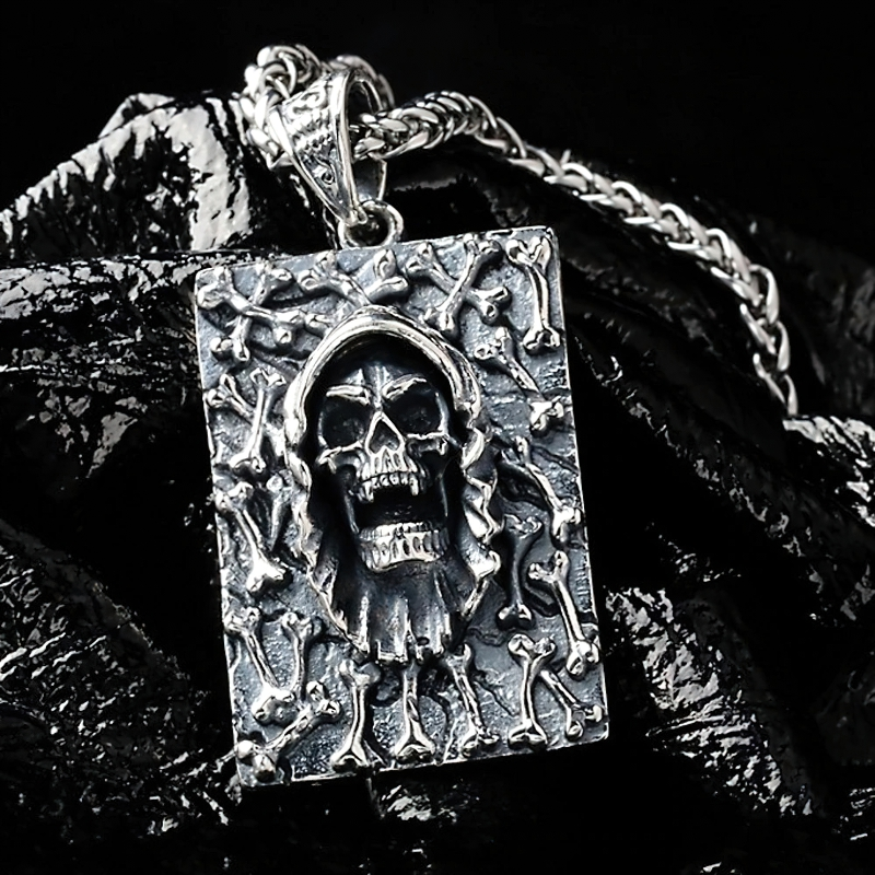 Men's rock style sterling silver pendant featuring a skull and bones design, perfect for alternative fashion enthusiasts.