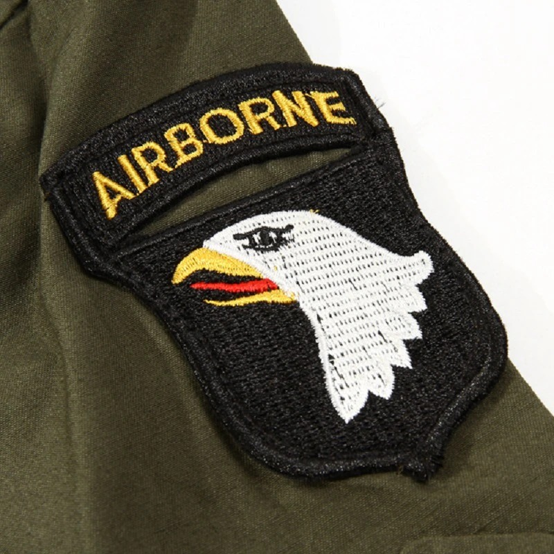 Close-up of an embroidered Airborne patch featuring an eagle on military green fabric.
