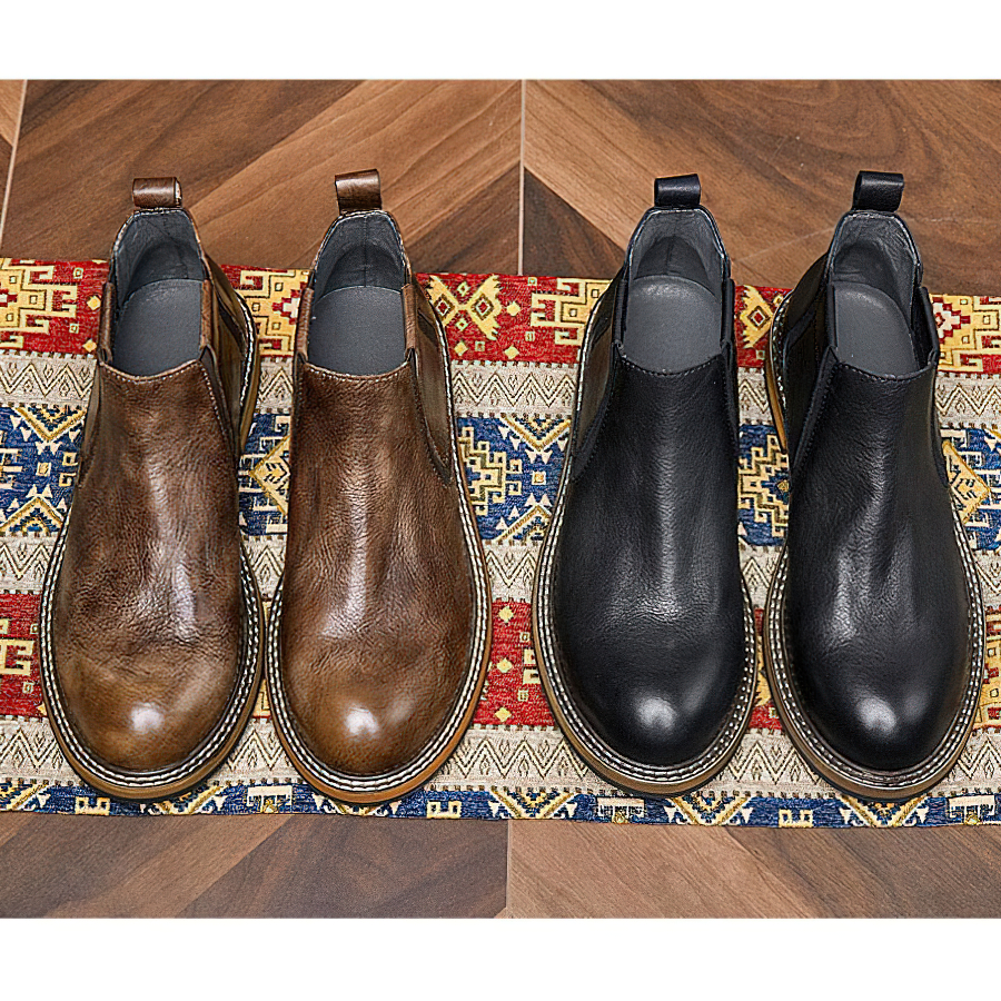 Men's soft leather ankle boots in brown and black color options on an elegant patterned rug.