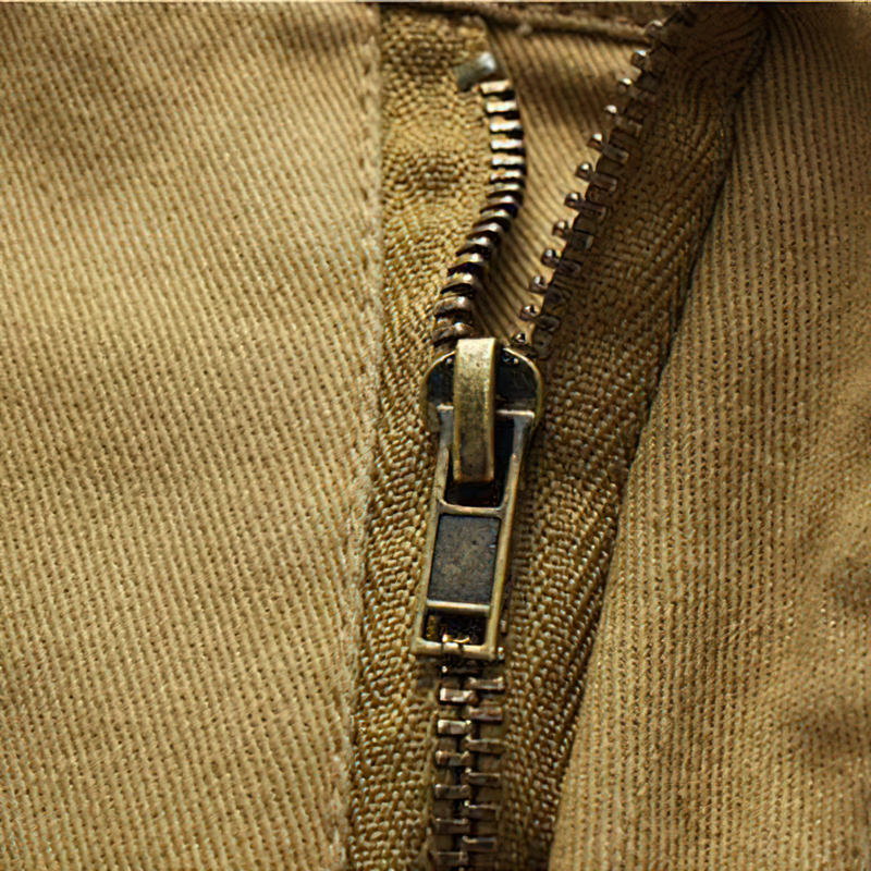Close-up of a zipper detail on men's solid cargo shorts, showcasing quality craftsmanship and durability.