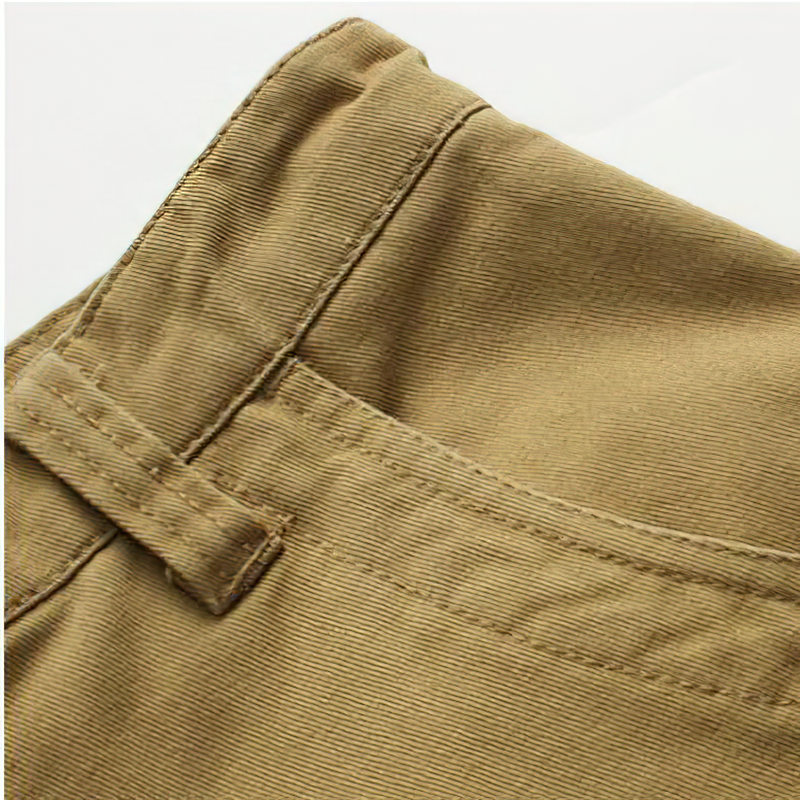 Close-up view of the waistband and stitching of men's solid cargo shorts in khaki color.