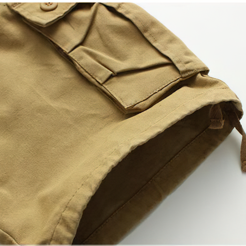 Close-up of men's solid cargo shorts featuring a pocket and soft fabric, ideal for casual summer wear.