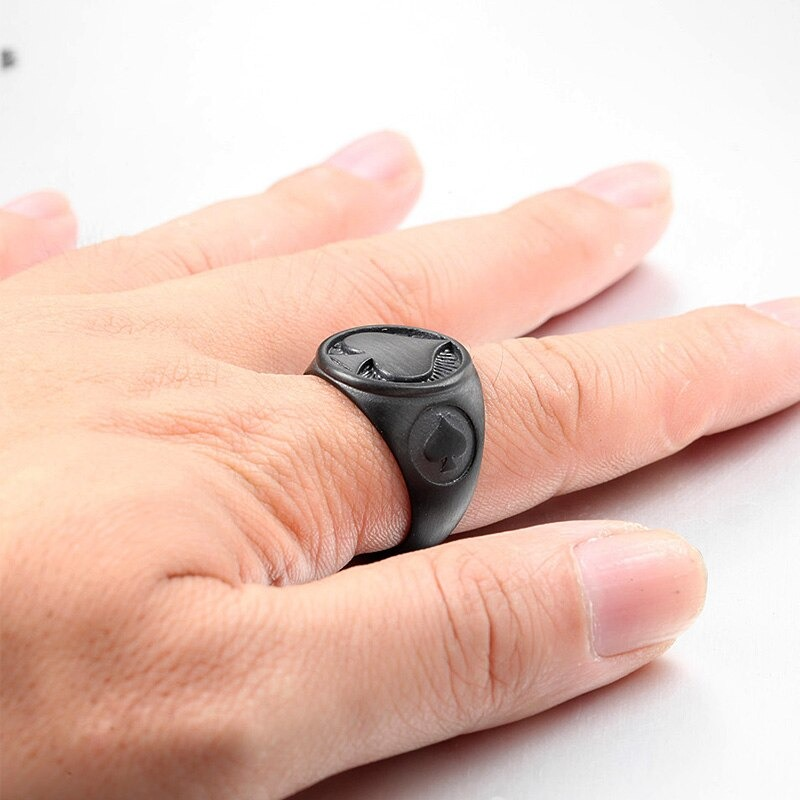 Men's black stainless steel ring with spade design worn on a hand, perfect for vintage rock style outfits.