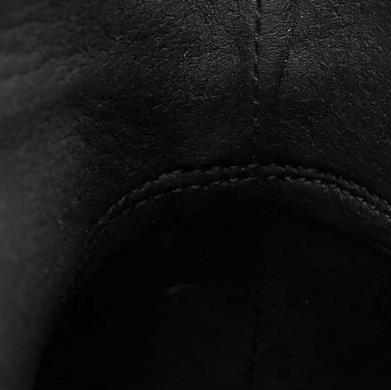 Close-up of the inside lining of stylish men's black leather ankle boots.