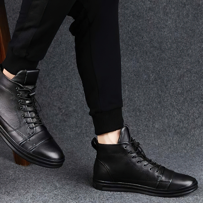 Men's stylish black leather ankle boots for casual wear with flexible sole.
