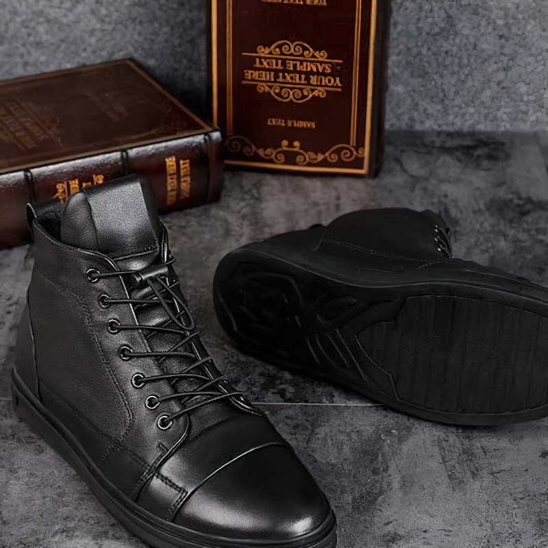 Men's black leather ankle boots with lace-up design, showcasing casual style and flexible soles for comfort.