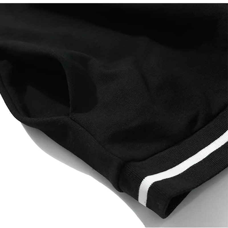 Close-up of black men's oversized sweatshirt featuring a stylish white striped hem.