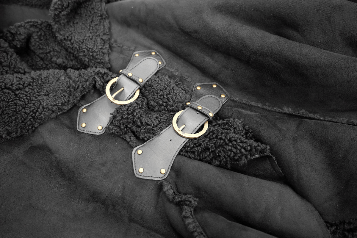 Close-up of buckled straps on a men's black irregular cloak with vintage design.
