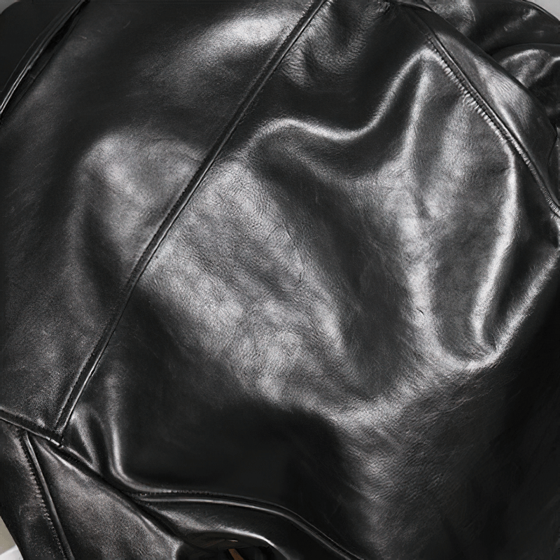 Close-up of a luxurious black waxed horsehide leather, showcasing its rich texture and classic biker style.
