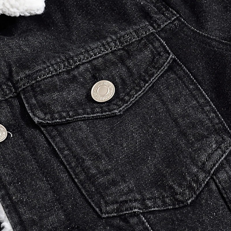 Close-up of black denim jacket with fleece lining and silver button details, perfect for winter style.