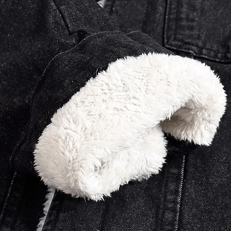 Close-up of plush fleece lining inside men's black denim jacket for winter warmth.