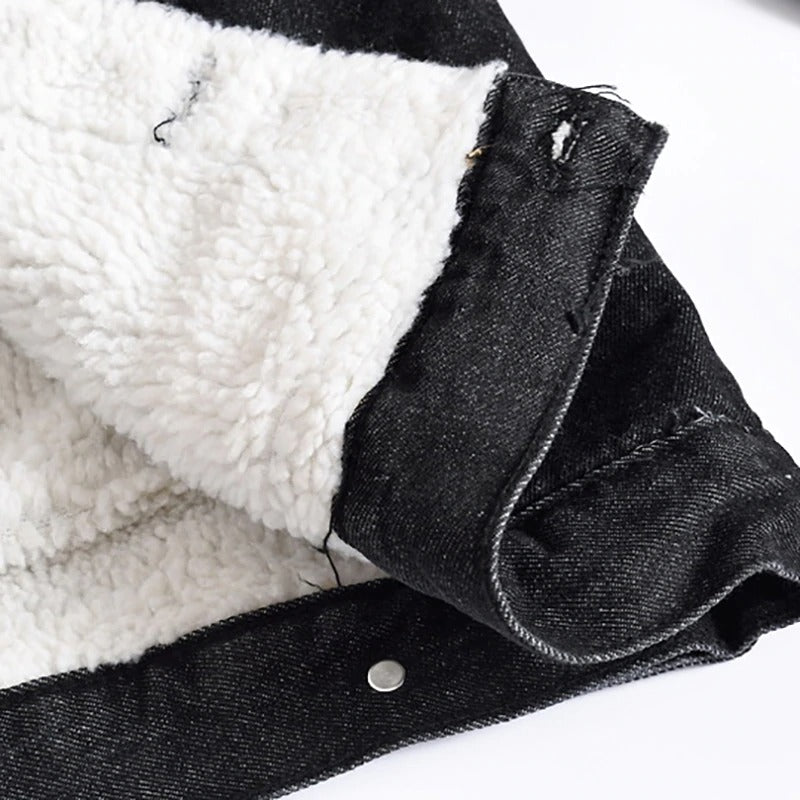 Close-up of the cozy fleece lining inside a men's black denim jacket, perfect for winter warmth and style.