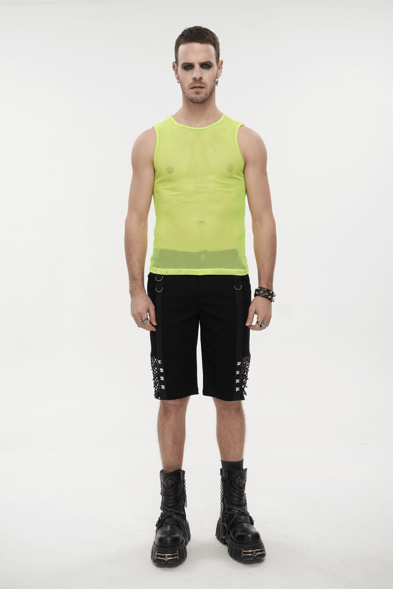Model wearing a men's yellow sleeveless mesh tank top paired with black shorts and boots, showcasing alternative fashion.