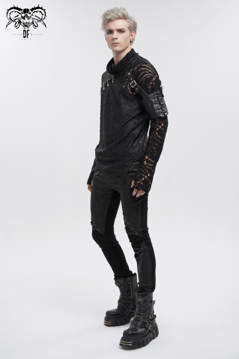 Gothic mesh asymmetrical top with pins, sleeve garter, and extended sleeves, styled with black pants and boots.