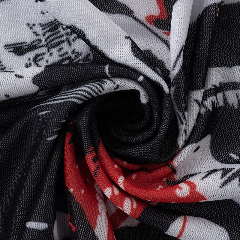 Close-up of black mesh fabric with alternating red and white patterns, perfect for alternative style women's tops.