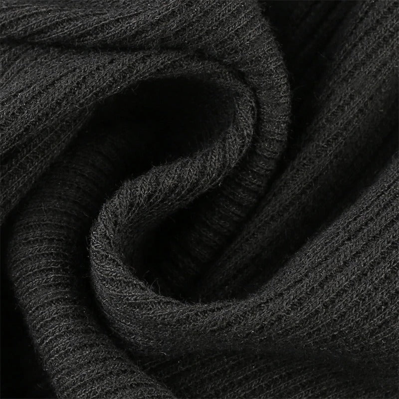 Close-up of soft black ribbed fabric, showcasing its texture and warmth, perfect for stylish bodysuits.